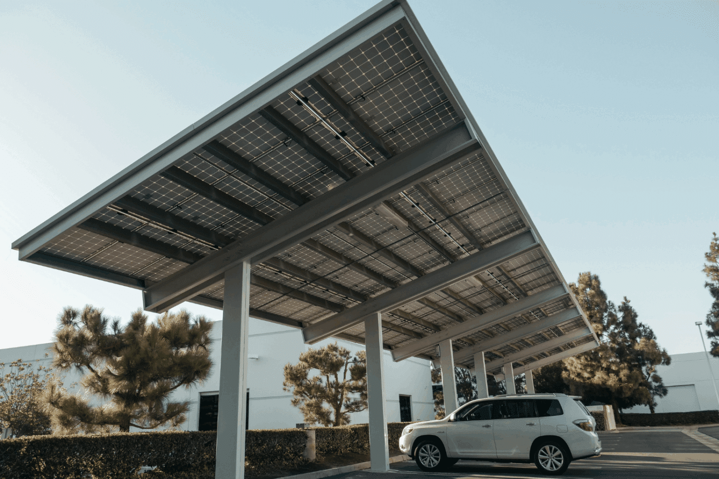White Flat roofed carports being used as car shades and as a solar installation