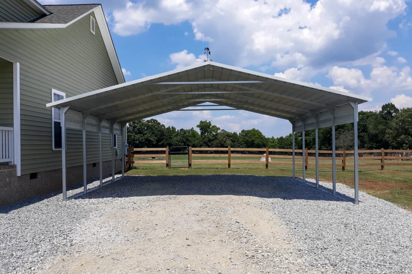 a Standard white open sided white carport with a weather vane on top